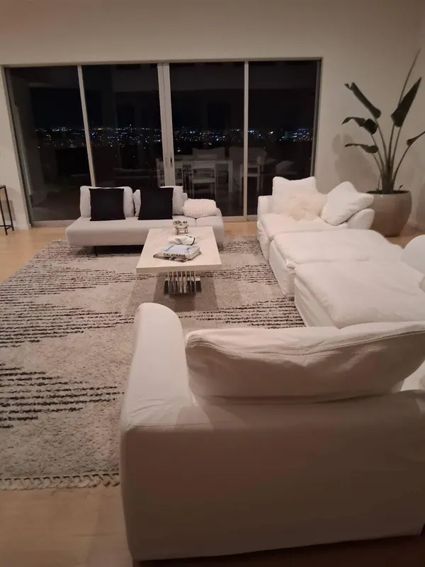Living room with white sofas, a marble coffee table and a striped rug after a regular cleaning visit in Beverly Hills